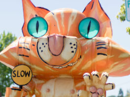 Cat sculpture preparing to mask up