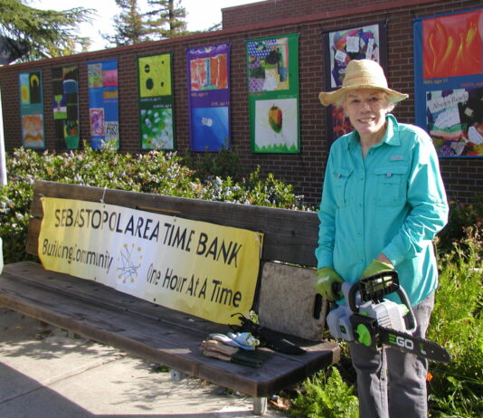 Time Bank volunteers clean up the gardens around the library and city hall