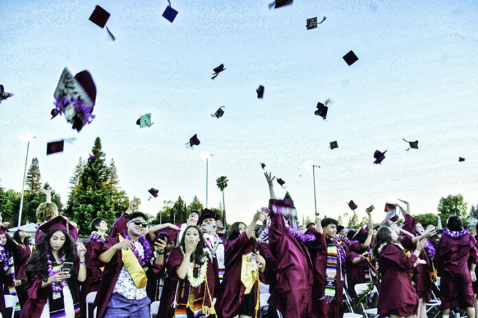 Graduates throwing hats in the air to celebrate