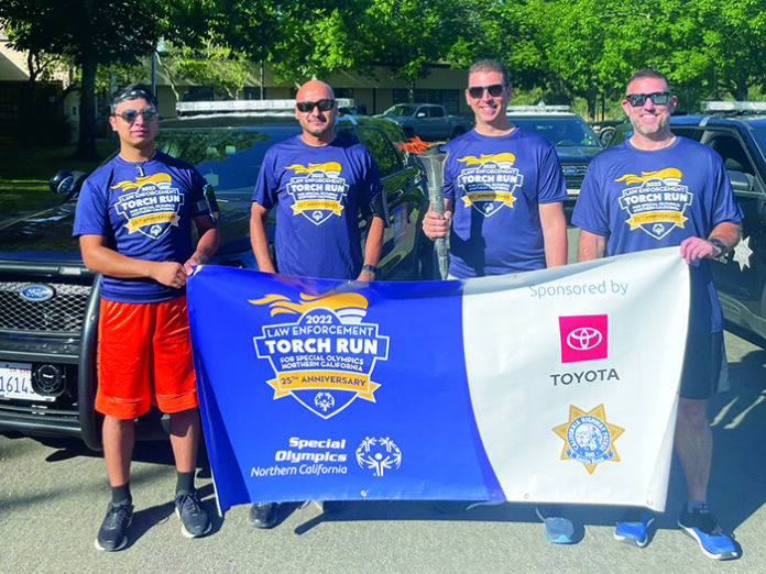 Members of the Healdsburg Police Department who participated in the June 2022 Law Enforcement Torch Run for Special Olympics. From left, Angel Rodriguez, Lt. Luis Rodriguez, Chief Matt Jenkins with torch, and Officer Nick Doherty.
