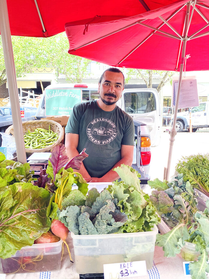 Sam works the Middleton Farm produce booth at a recent Tuesday Farmers’ Market. He says Middleton Farm has attended the Healdsburg Farmers’ Market since 1989.