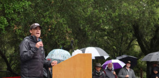 Mike McGuire giving speech in the rain