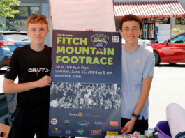 Two runners with sign