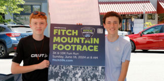 Two runners with sign