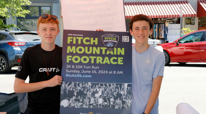 Two runners with sign