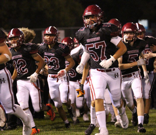 Greyhounds End Long Winless Drought Football team running onto field