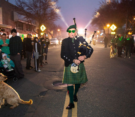 Bagpiper leading pre-dawn parade