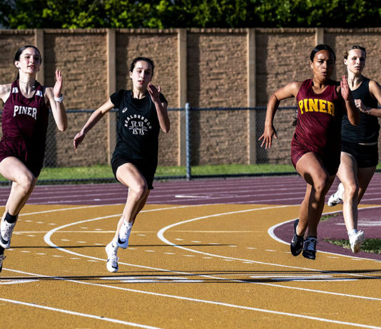 Four girls from Piner and Healdsburg run in a dual match in april 2025.