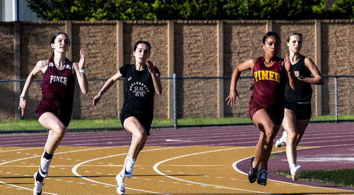 Four girls from Piner and Healdsburg run in a dual match in april 2025.