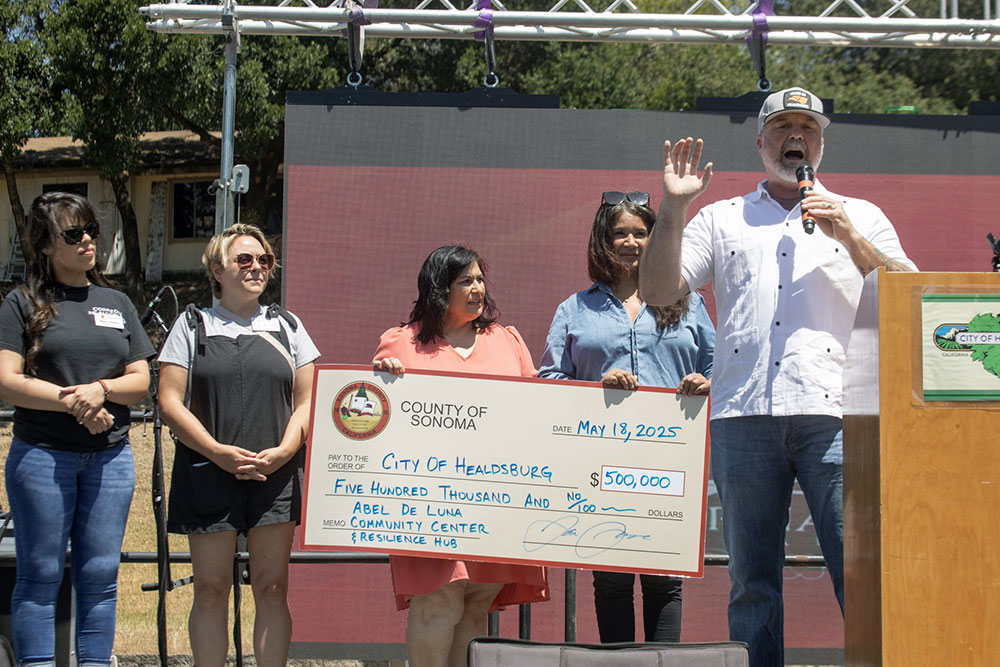 Supervisor James Gore and a large check