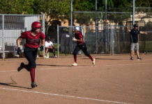 Batter headed for first as runner heads for home