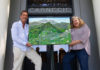 Michael Lightfood presents a painting representing Healdsburg in 1972, as seen from the air.