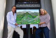 Michael Lightfood presents a painting representing Healdsburg in 1972, as seen from the air.