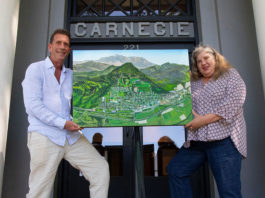 Michael Lightfood presents a painting representing Healdsburg in 1972, as seen from the air.