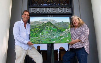 Michael Lightfood presents a painting representing Healdsburg in 1972, as seen from the air.
