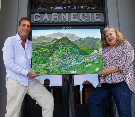 Michael Lightfood presents a painting representing Healdsburg in 1972, as seen from the air.