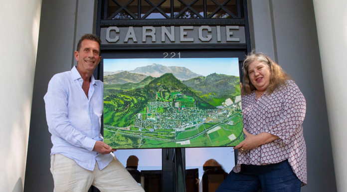 Michael Lightfood presents a painting representing Healdsburg in 1972, as seen from the air.