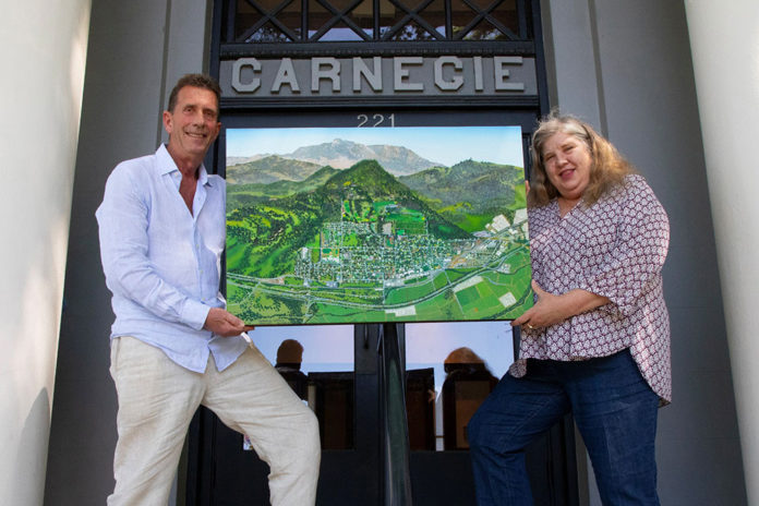 Michael Lightfood presents a painting representing Healdsburg in 1972, as seen from the air.