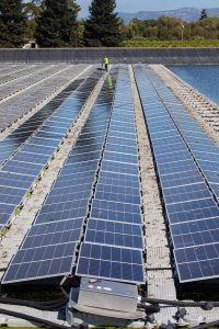 Solar panels on wastewater pond