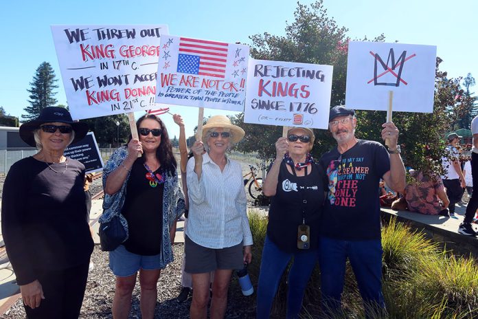 No KIngs protestor holding signs