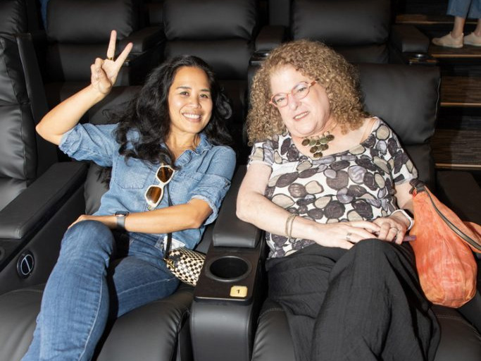 Happy filmgoers await the previews.