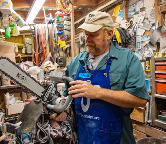 Sculptor T Barny with diamond saw