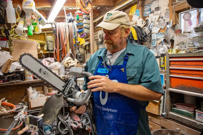 Sculptor T Barny with diamond saw