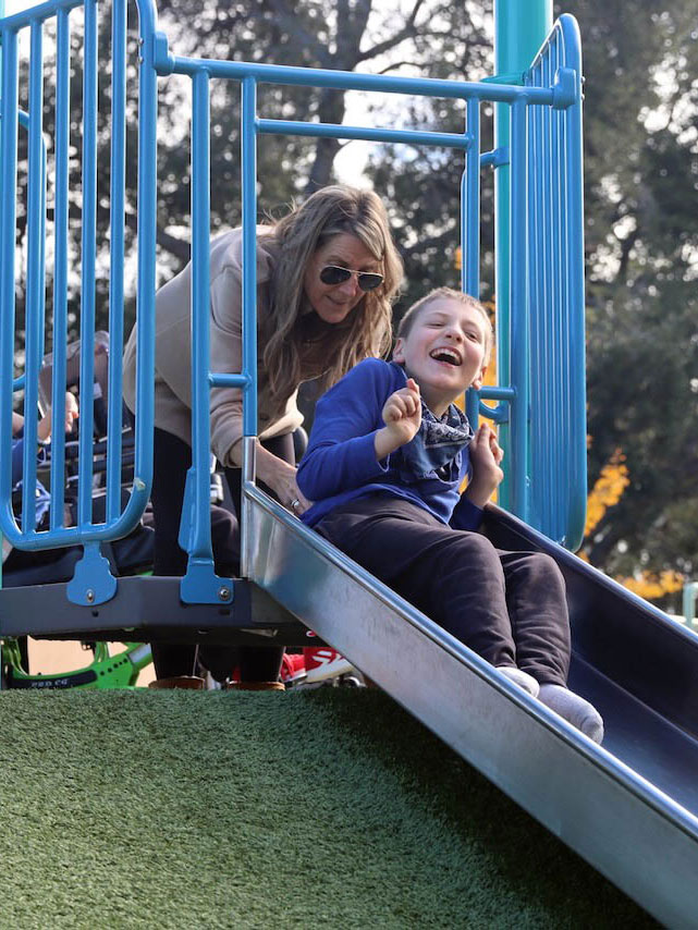 Playing on the slide at Magic Bridge