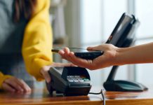 How Technology Is Changing Everyday Experiences in Small Communities Phone connecting with payment device