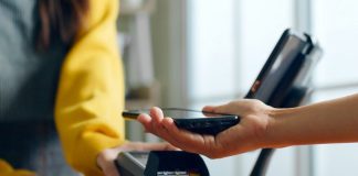 How Technology Is Changing Everyday Experiences in Small Communities Phone connecting with payment device