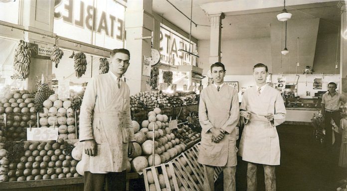 Staff of Jay Hassert's fruit and vegetable market, house, 1930s.