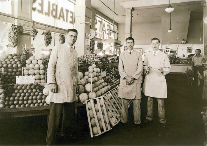 Staff of Jay Hassert's fruit and vegetable market, house, 1930s.