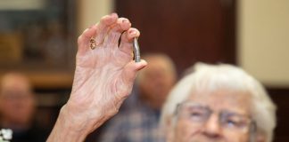 Alice Beck Darrow, 106 years old, holds aloft a silver bullet.