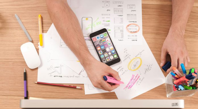 How Review Sites Help Users Make Informed Choices Person reading online reviews on laptop while taking notes at desk