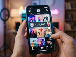 7 Best Sites to Buy TikTok Followers in 2026 Person holding a smartphone showing a short-form video feed with creator content and a visible increase in followers, in a softly lit indoor setting.